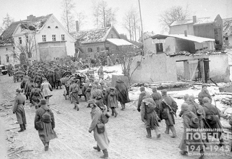 Soviet infantry passing through a German village on the approach to Konigsberg
