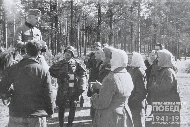 Policeman questioning the peasants about partisans