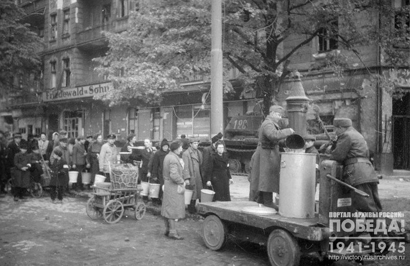 Residents of Berlin on one of the streets of the city waiting in line to get water