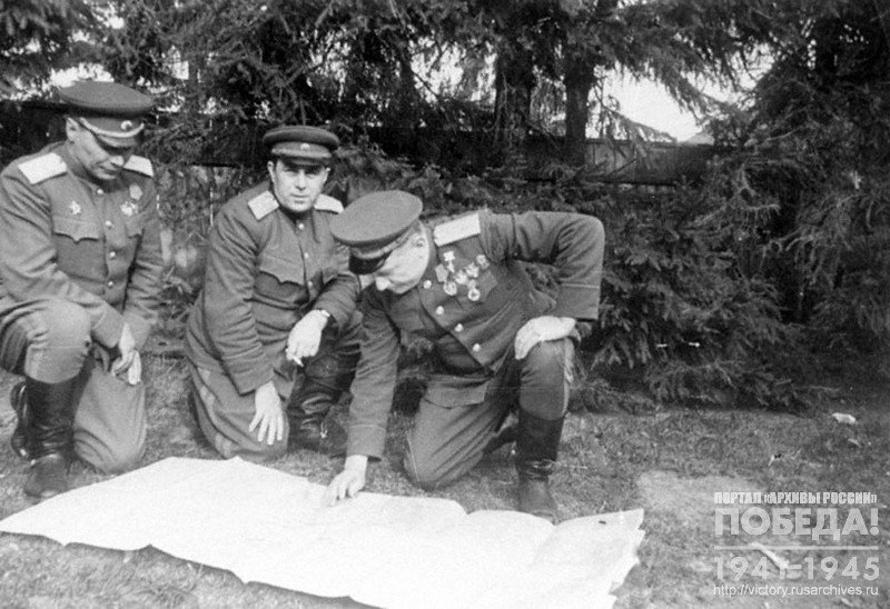 Commanders of the Soviet forces that have entered Botashany Lieutenant Generals F.F.Zhmachenko, I.Z.Susaikov and Major General Kulik near the map