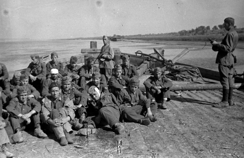Italian and Romanian soldiers captured near Stalingrad on a barge going to the rear