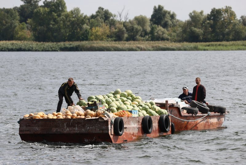 Locals transporting food supplies across the Dnipro River (Kherson)