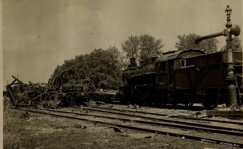 Image: In the southern part of the Shklov station, in front of the locomotive, completely wrecked and destroyed cars from the bombing of attack aircraft and the explosion of a pile of shells caused by it