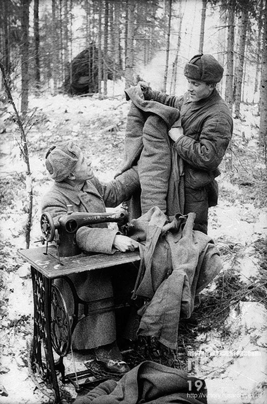 Soldier Davydov from the unit of Captain Pavlov gives out an overcoat after repair