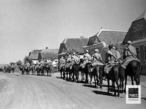 Cossack unit rides through a liberated Romanian village. Romania. August, 1944