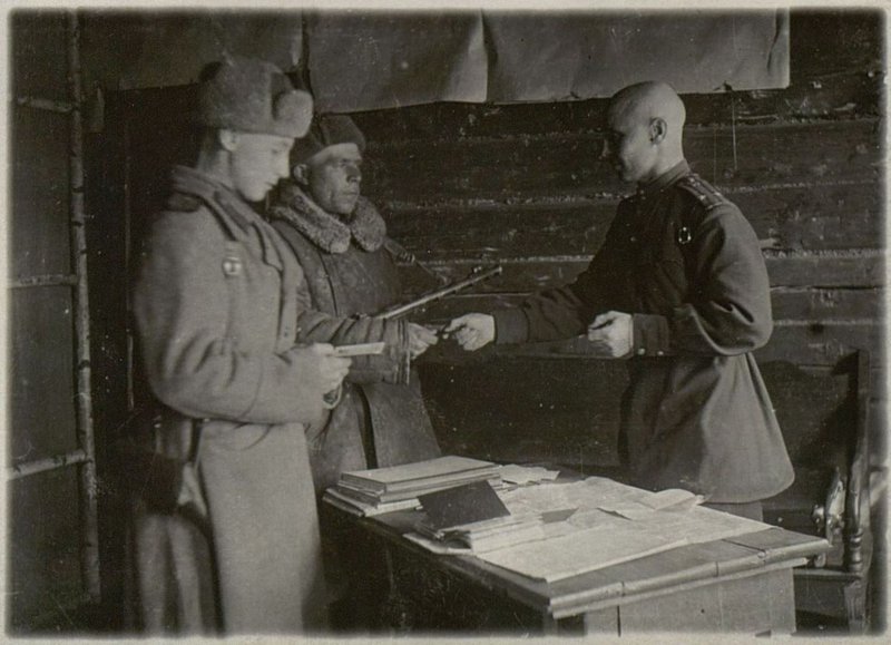 Image: Deputy the brigade commander for political affairs, Lieutenant Colonel Yablokov presents party cards to Senior Lieutenant Tsarev and Sergeant Nanakin