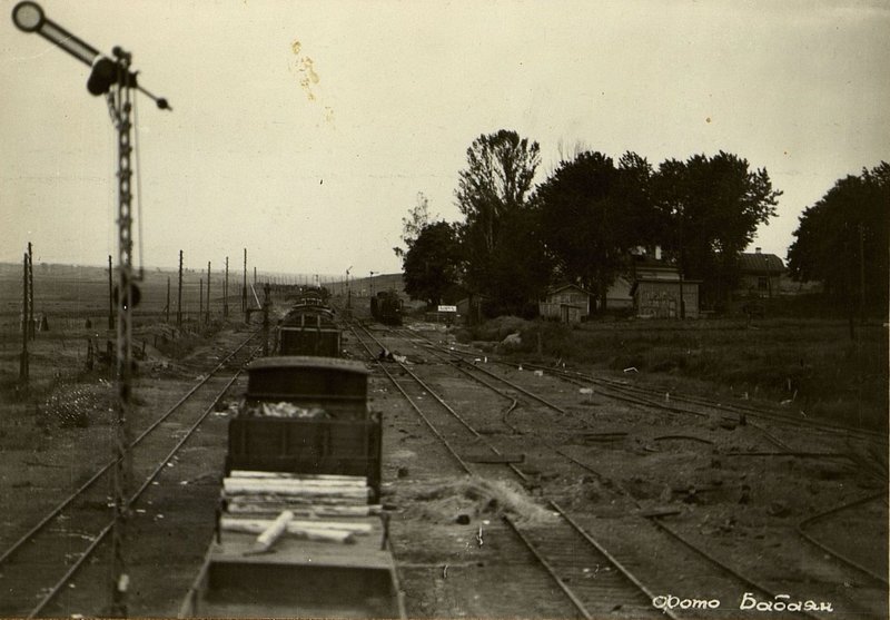 Image: View of the railway tracks broken by bombing at the Kopys station. The depth of the central funnel is visible from comparison with the members of the commission who are in it.