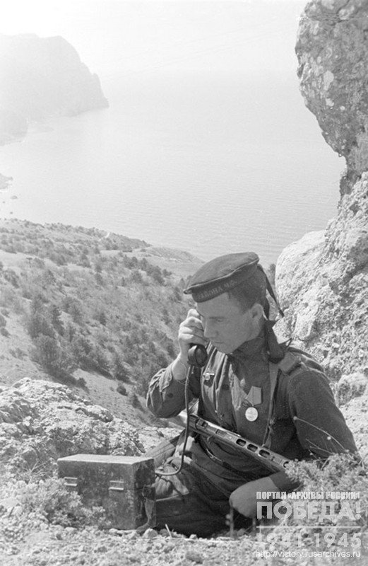 Sailor-signalman V. Sanin establishes telephone communication on the approaches to Sevastopol. Crimea, 1944