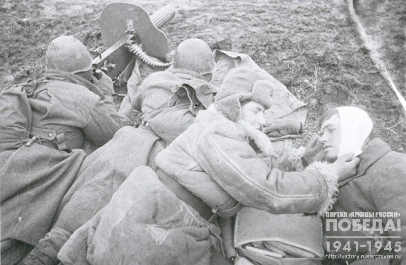 Combat medic O.Maslichenko giving medical assistance to wounded soldiers