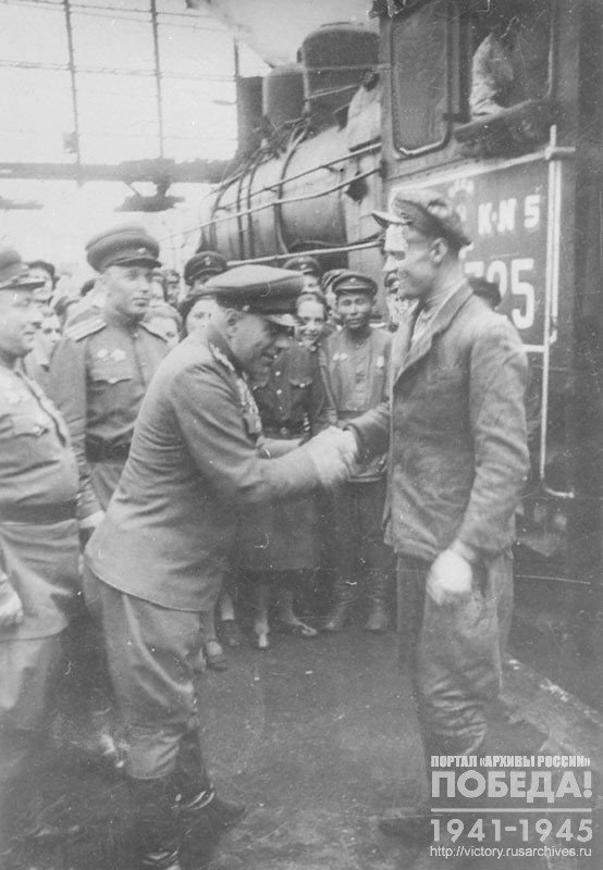 Representative of the Berlin commandant's office congratulates the train driver V. Smirdin, who brought the first passenger train from Moscow to Berlin