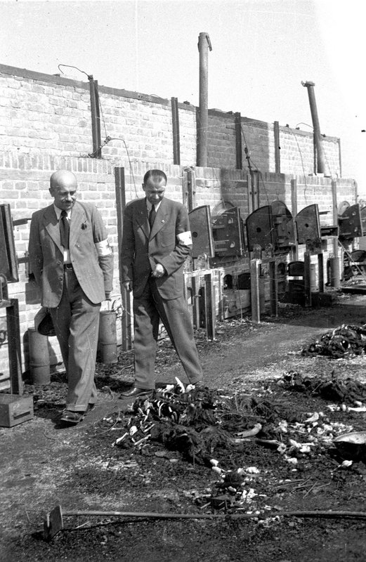 Representatives of Red Cross by crematorium furnaces examine the remains of tortured people  on the territory of Majdanek concentration camp