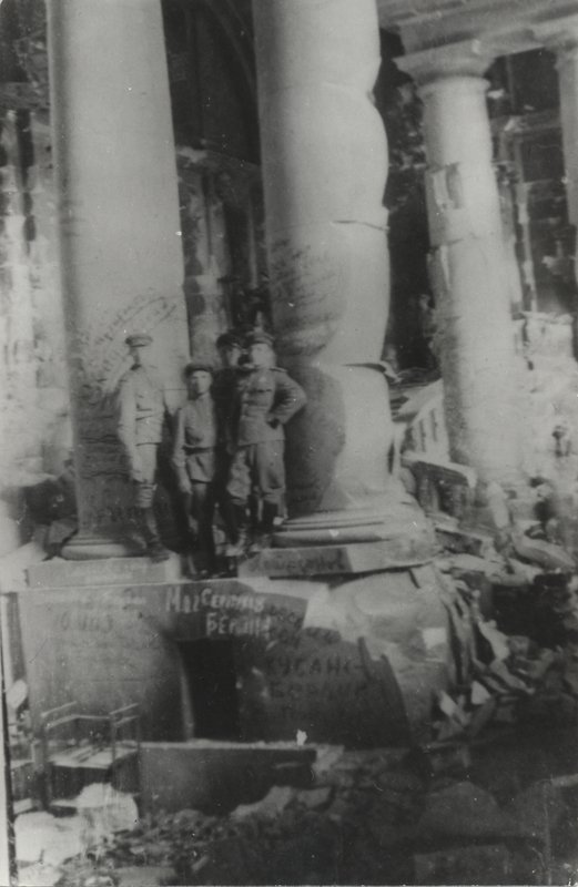 A. M. Skidal'sky stands with a group of Soviet officers near a column of the Reichstag