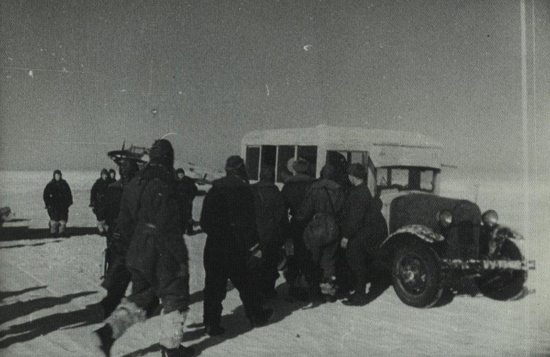 Pilots near the mobile kitchen bus while dining in the field conditions