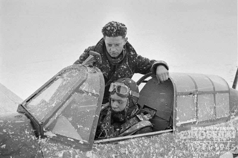 Soviet fighter pilot V. Maksimovich is being trained to operate the British fighter "Hurricane" by English mechanic Paul Votsevus