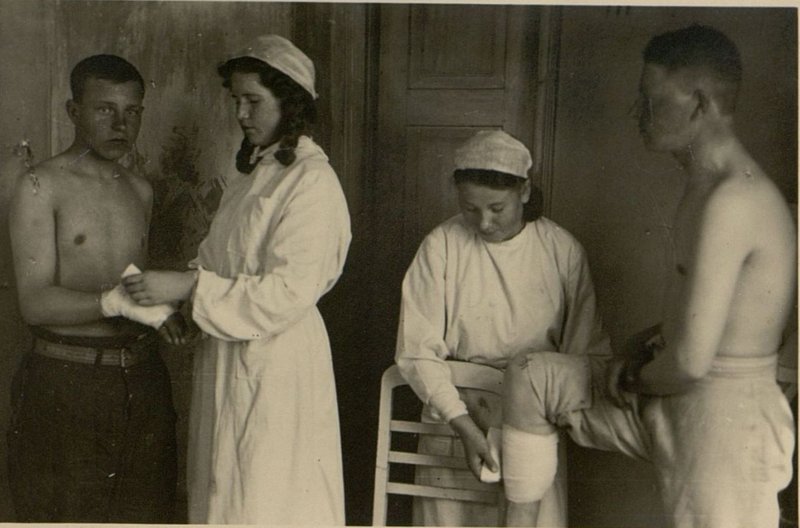 Image: In the medical unit, a battalion of convalescents: Nurses A. Polovinkina and A. Artemovskaya bandaging patients