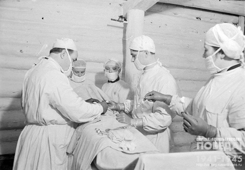 Doctors operating in a field hospital