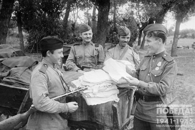Petty officer of the machine-gun company G. Dernovoy gives out underwear to his soldiers