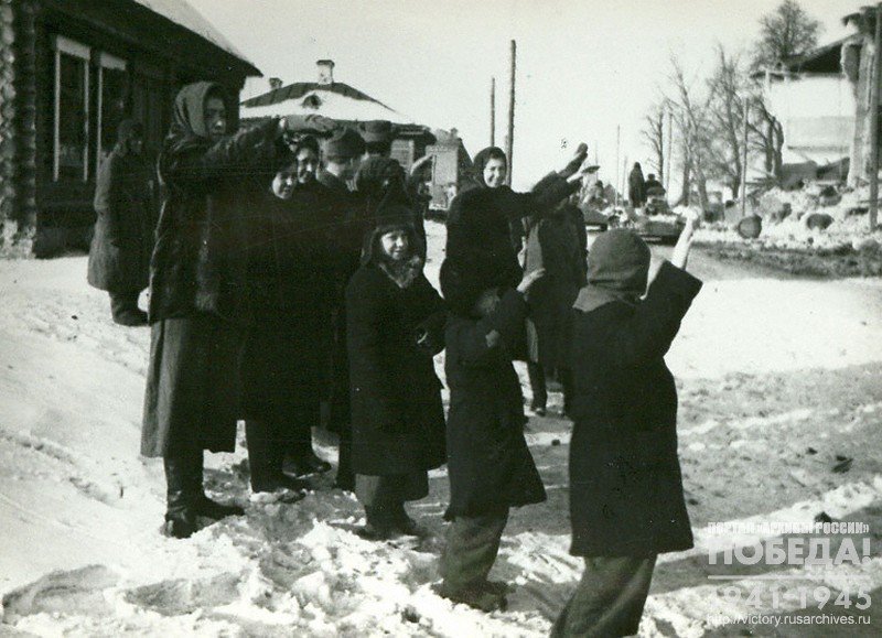 Residents of the town of Yukhnov, liberated from the fascist invaders, greeting the Soviet soldiers