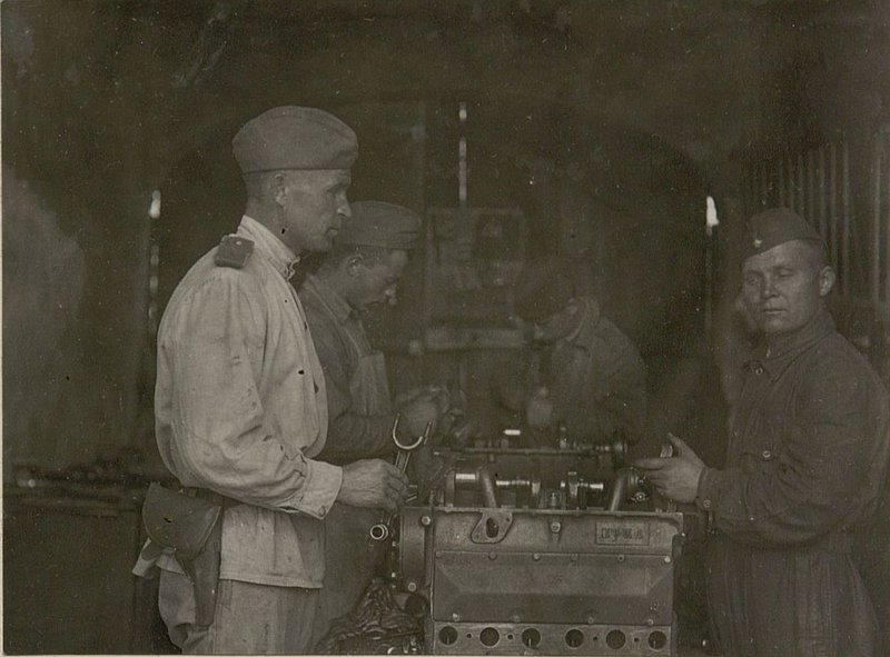 Image: 821 Aviation Service Battalion Auto mechanic sergeant G.I. Marchenko checks the work of a locksmith