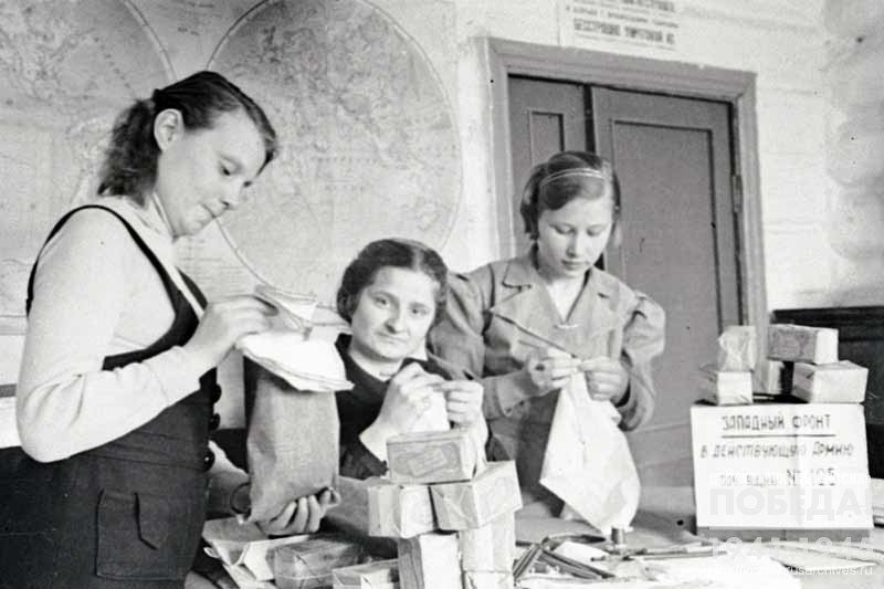 Komsomol members, participants of Stakhanov movement from Barnaul railcar repair plant embroider handkerchiefs as a gift to the soldiers of the Western Front