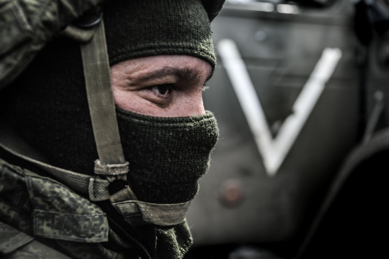 Service member from the Grad multiple launch rocket system crew next to the Grad MLRS vehicle in the special military operation area in Donetsk Oblast, Russia