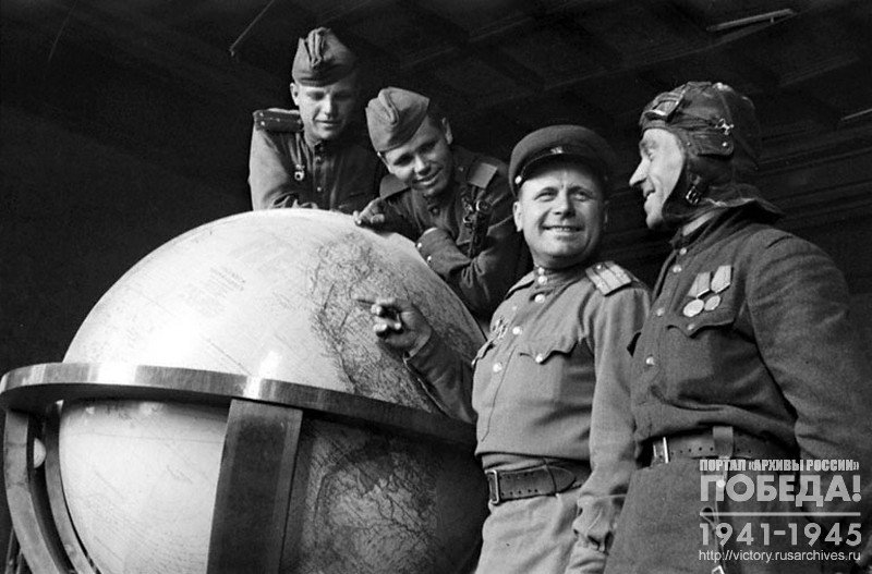 Soviet soldiers at the globe used by Hitler