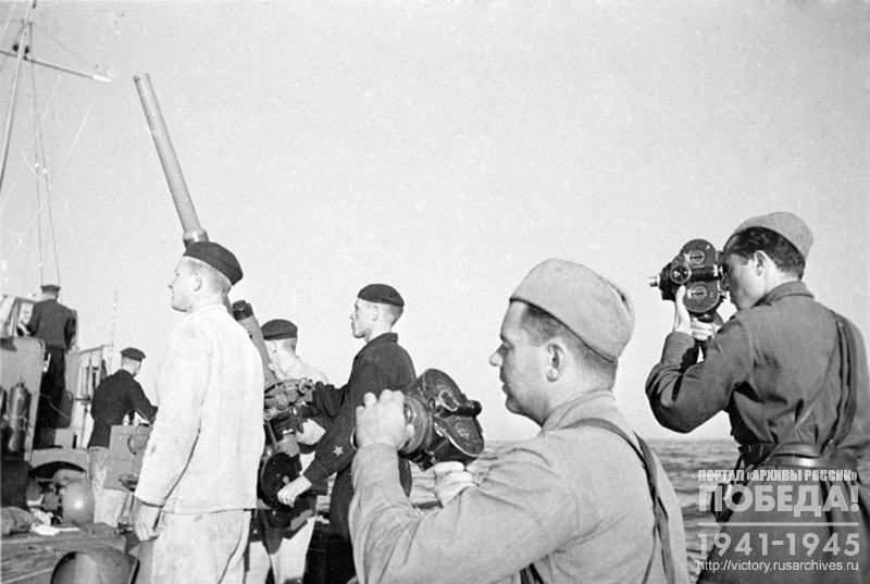 Cameramen M. Troyanovsky and S. Kogan during filming on the deck of one of the ships of the Black Sea Fleet