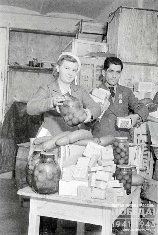 Employees of the Department of trade organizations of Krasnodar N. Lycheva and M. Amirkhanov pack parcels with gifts for Soviet soldiers