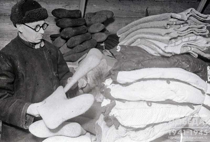 Supervisor of the Kuntsevo Warehouse V. Aleshukin prepares warm clothes collected by residents of the district to be sent to the front