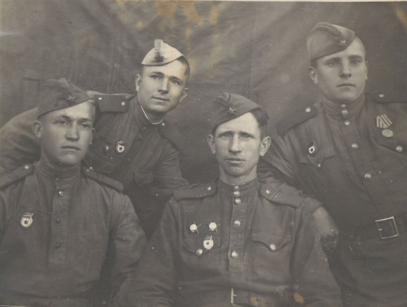 Private Mikhail Efimovich Gusarov (standing right) with war comrades from his regiment
