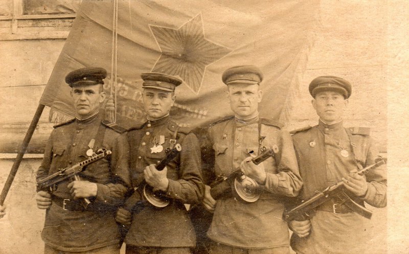Under the Regiment's Banner. August 1943. The leftmost - a participant of actions near the town of Brest in 1941 Bursikov F.V. The offensive of the Soviet troops was being prepared not far from the town of Staraya Russa. 3 days before the offensive the group pictured in this photo was sent to the neutral territory. Their task was to detect and identify enemy firing points. The task was completed successfully.