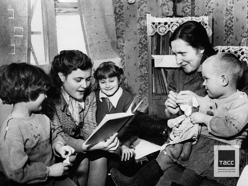 Workers of plant “Red bogatyr” with their adopted children, who lost their parents during the war