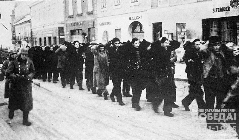Polanders arrested by the Germans marching through a street of one of the towns in Silesia