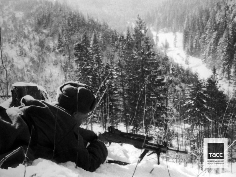 A soldier of one of the units of the 4th Ukrainian Front with a machine gun at a firing point in the Carpathian Mountains