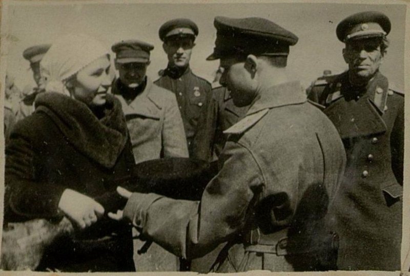 Image: Collective farmer of the Starobelsk district of the Voroshilovgrad region O.D. Romashko presents military weapons to the officer of the unit, Lieutenant Colonel Gavrilenkov, acquired with funds from her labor savings and donated by O.D. Romashko to the Country Defense Fund in the amount of 30,000 rubles