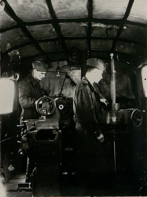 Image: Mechanical workshop of a repair platoon. From left to right: turner Bilichenko and borer and grinder Orlov.