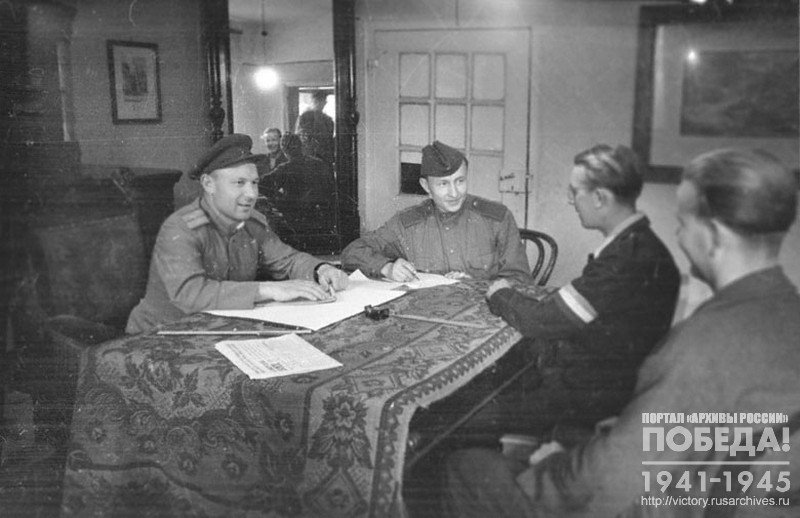 Captain I. Gorbenko, the chief of staff of the collection and transfer point #31 for the repatriation of prisoners of war talks with arrived foreign prisoners of war