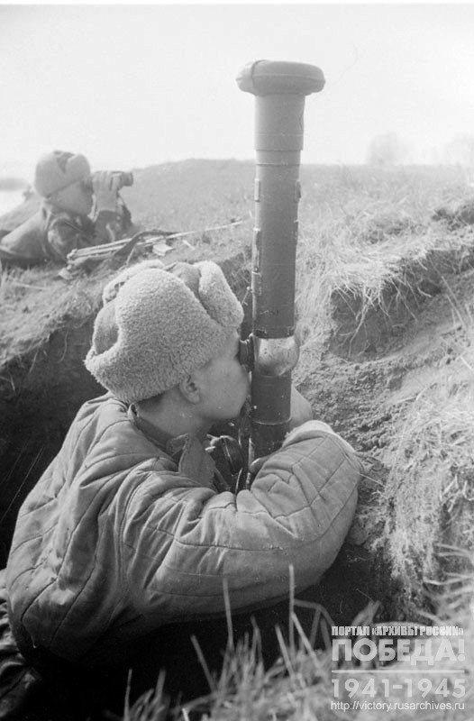 Second Lieutenant I. Makhov and Lieutenant T. Argunov, who crossed to the Western Bank of the river Oder as part of the lead landing force, are monitoring the enemy through a captured stereo tube