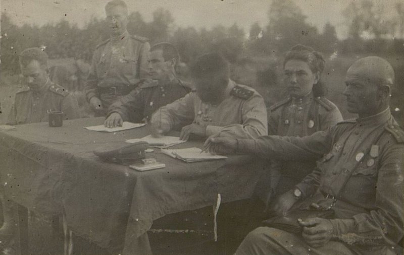 Image: The presidium of the general party meeting of the regiment, held on July 12, 1944 in the eastern region of Minsk, with a discussion of the report of the regiment commander, Lieutenant Colonel Akhtyrchenko, on the results of hostilities and the march in June-July 1944 and the tasks of the regiment's communists in the upcoming march.