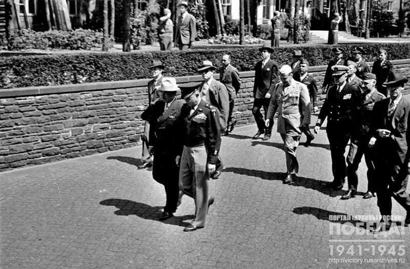 US President G. S. Truman and General D. Eisenhower walking through airfield on arrival day to Berlin Conference