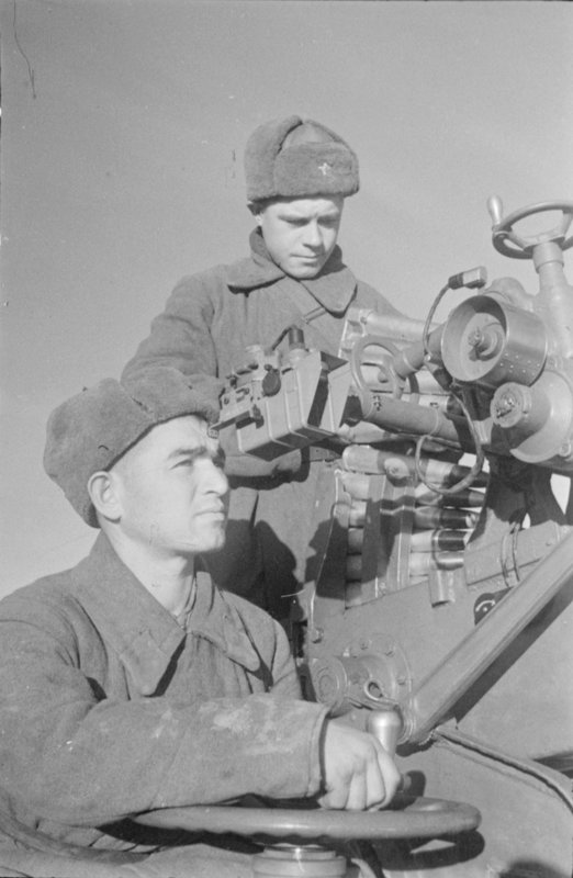 Excellent anti-aircraft artillerymen Corporal H. Husseinov and Private I. Vova at their gun
