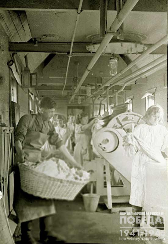 Washing clothes in one of the cars of the bath-Laundry and disinfection train, built at the expense of the Central Council of Trade Unions, and transferred to the troops of the Bryansk Front