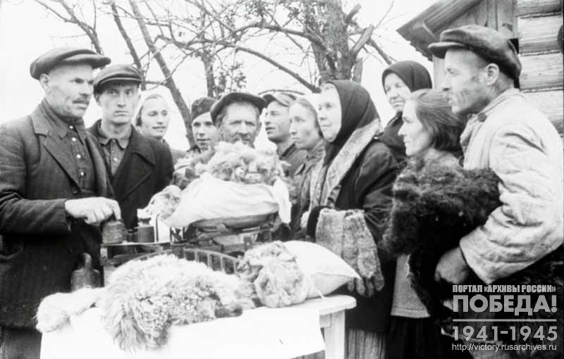 Workers of the collective farm "Awakening" of the Ivanovo District hand over warm clothes to be sent as gifts to soldiers