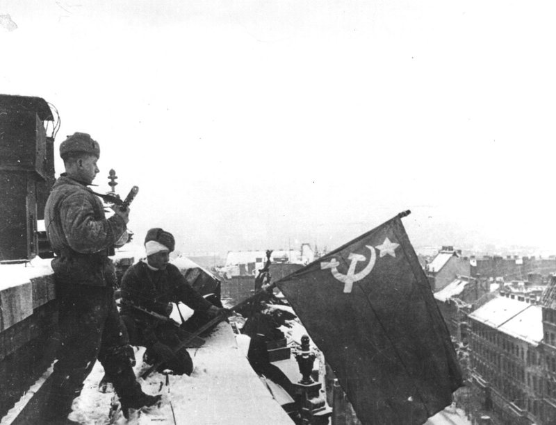 Soviet soldiers hoist the Red Banner on one of the buildings of Budapest