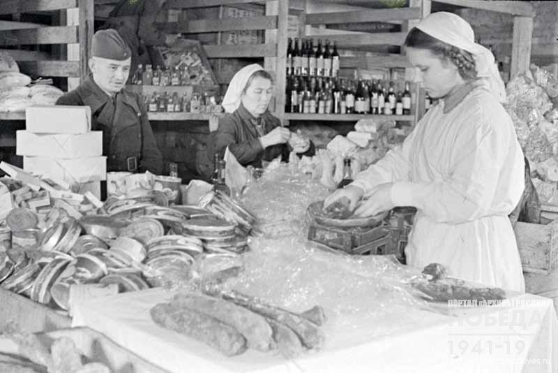 Preparing of individual food parcels for Soviet soldiers as gifts from the workers of Dalstroy in one of the warehouses of Magadan