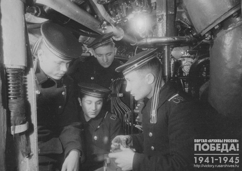 Komsomol members, sailors of Guards submarine "M-171" torpedoman A. Mozhartsev, bilge sailor D. Rzabekov and others studying the mechanisms of the engine room of the boat