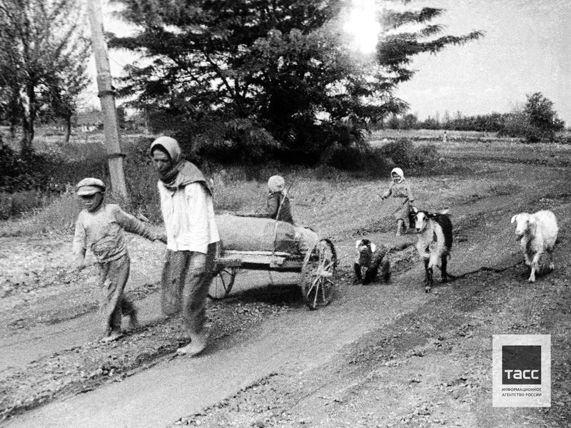 Mother with her children leave their home village because of the advancing of German army.