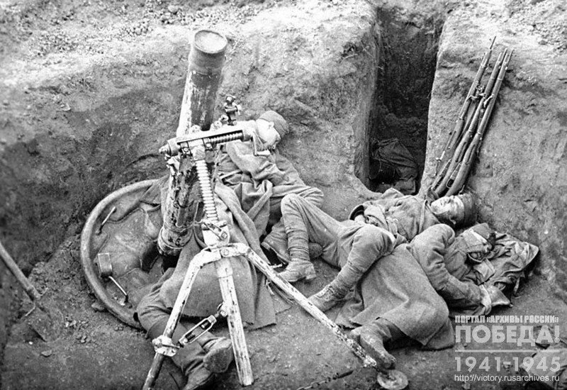 Soldiers sleep at their guns in the trenches after the battle
