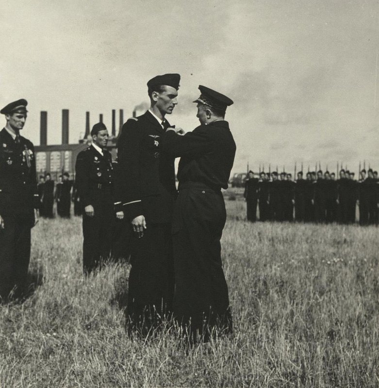 The Chief of the General Staff of the French Air Force, General Marsial Valen, awards one of the pilots of the Normandy-Niemen air regiment. France, Paris, Le Bourget Airport, June 1945