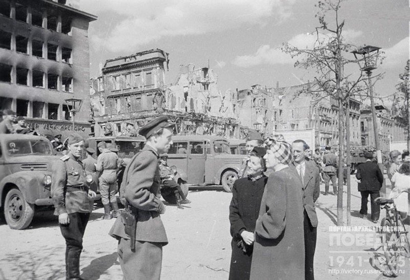 Soviet officers talk to residents of Berlin